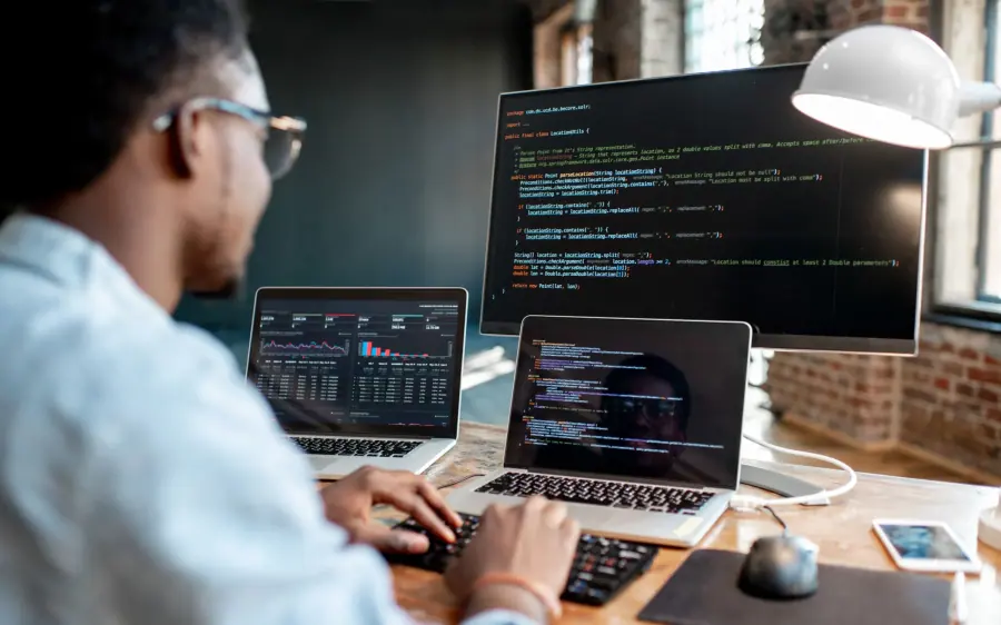 Developer writing code on a laptop