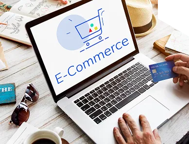 Laptop showing an e-commerce checkout while a customer holds a payment card