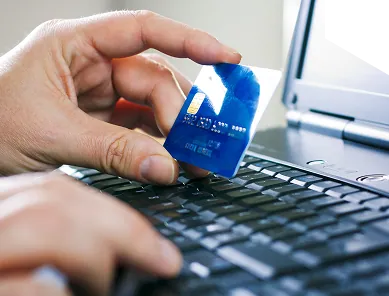 Hand inserting a payment card into a card reader